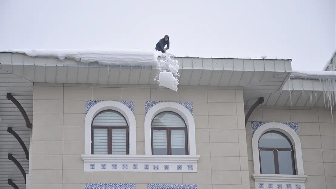 Muş'ta işçiler bellerine bağladıkları iplerle çatılarda kar temizliyor